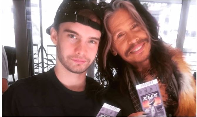 A smiling picture of Taj Monroe Tallarico with his father Steven Tyler